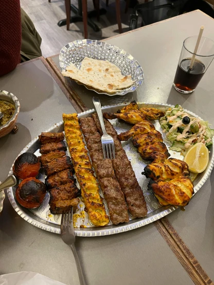 a plate filled with lots of assorted meat on top of a table