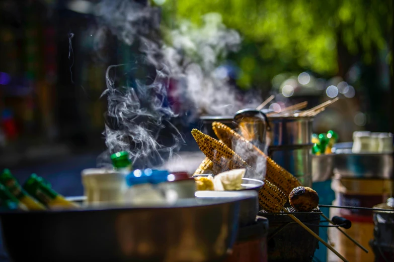 many food items and silver pots with steam coming out