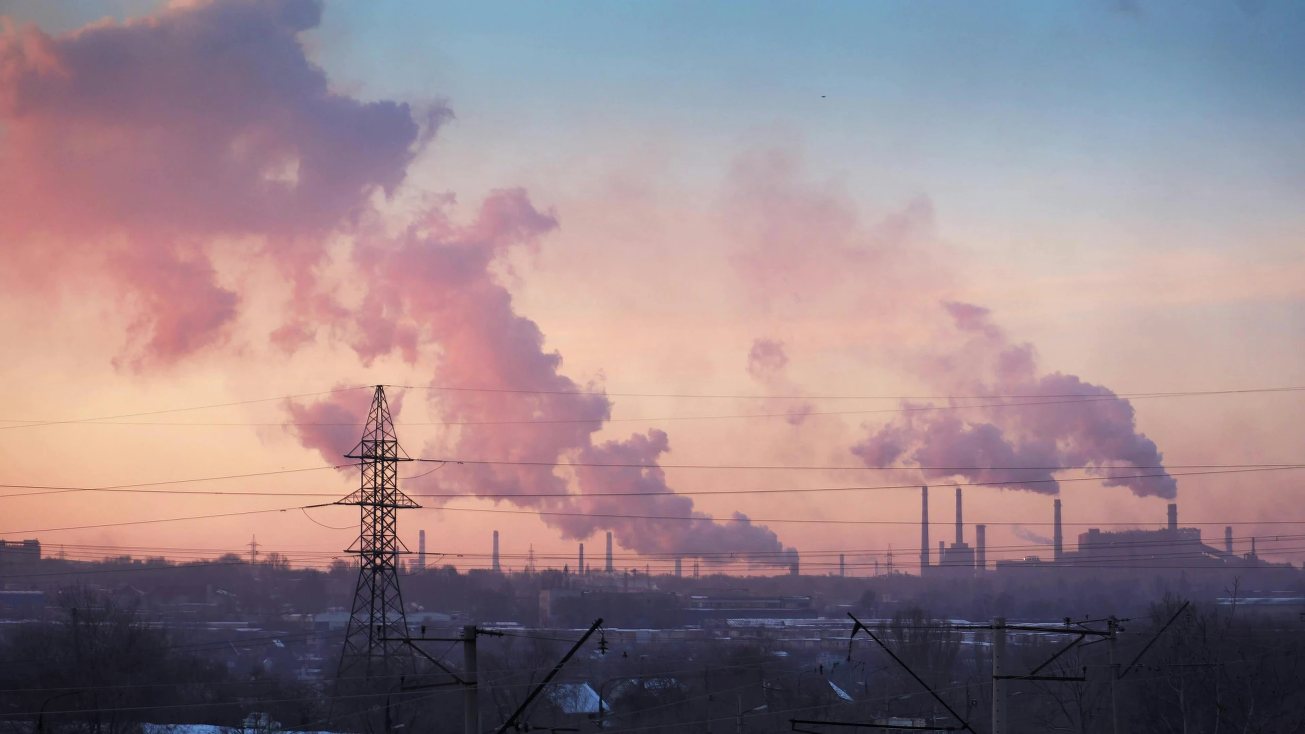 smoke rises from an area with high rise power lines