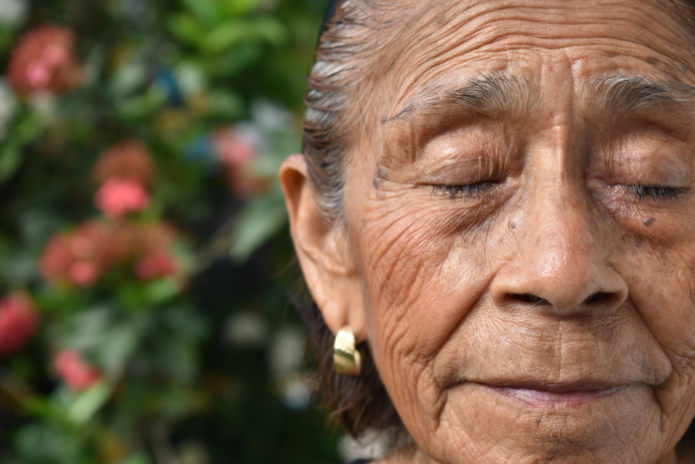 an old woman with earrings and earrings on her ears