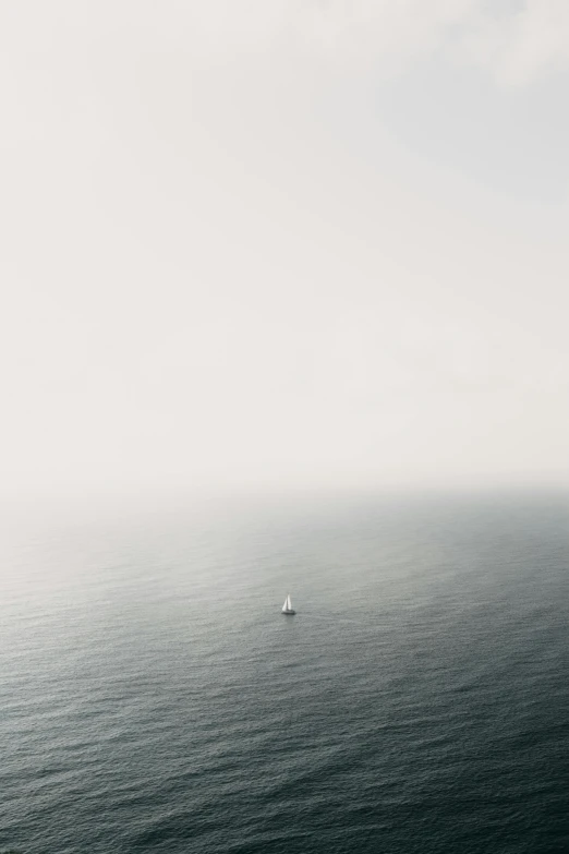 a small boat traveling on top of a large body of water