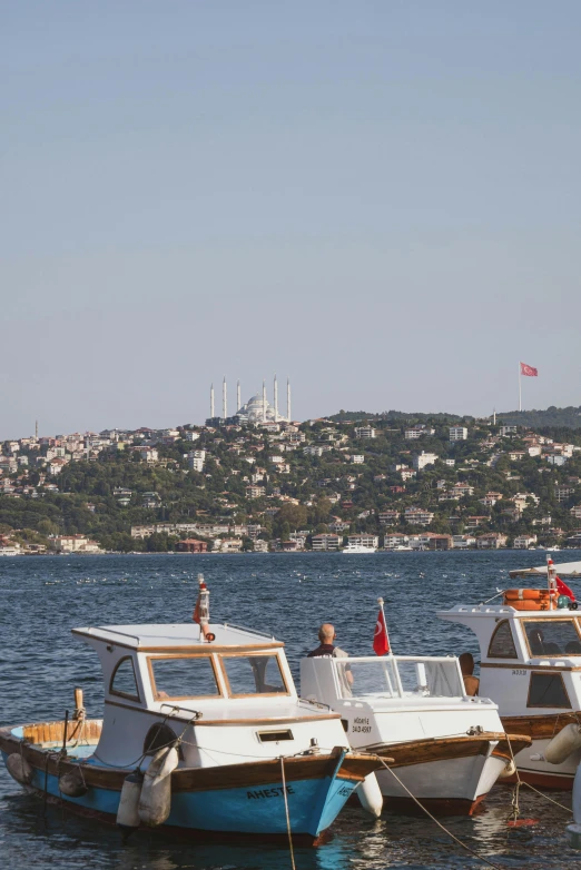 several small boats are docked at the pier