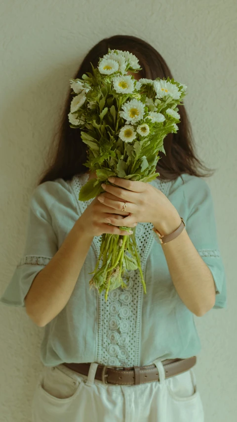 a woman is holding flowers and posing for a picture