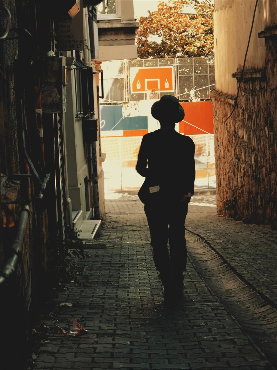 an individual is walking down a brick street