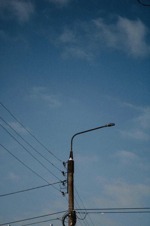 a tall street light on the side of a road