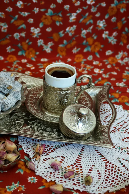 there is a cup of coffee and a plate with some tea on it