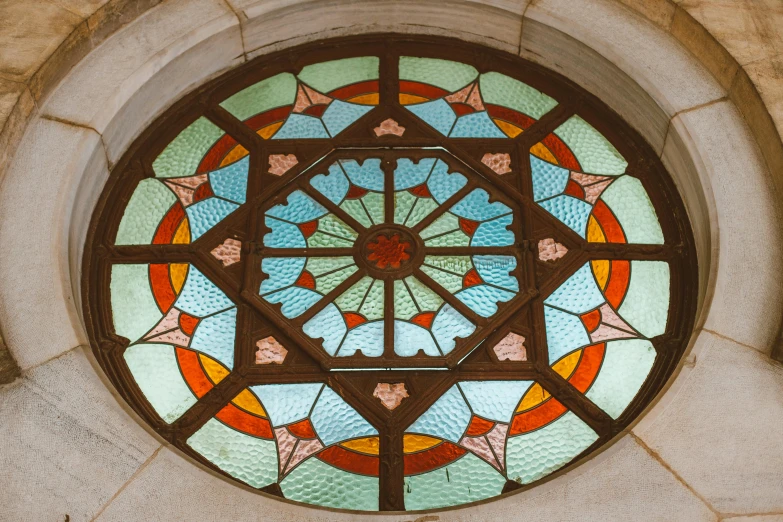 a circular stained glass window inside of a wall