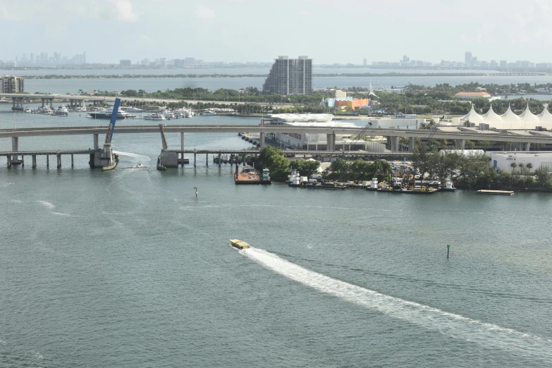 a boat is traveling across water near a city