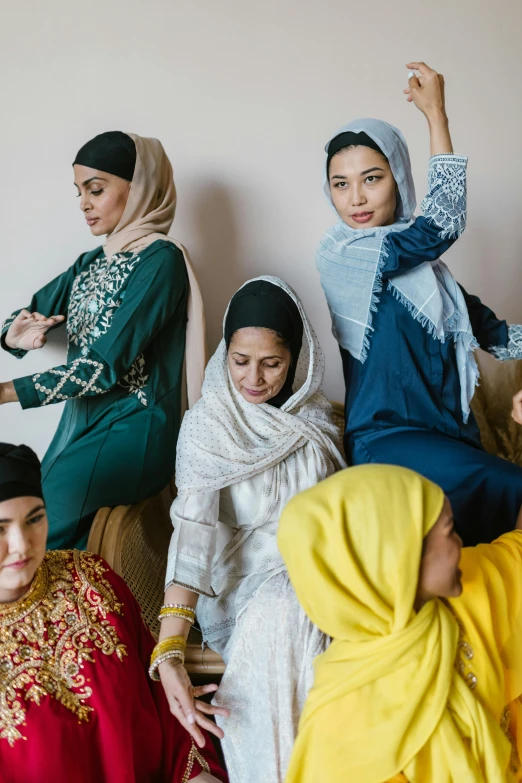 a group of women sitting around each other