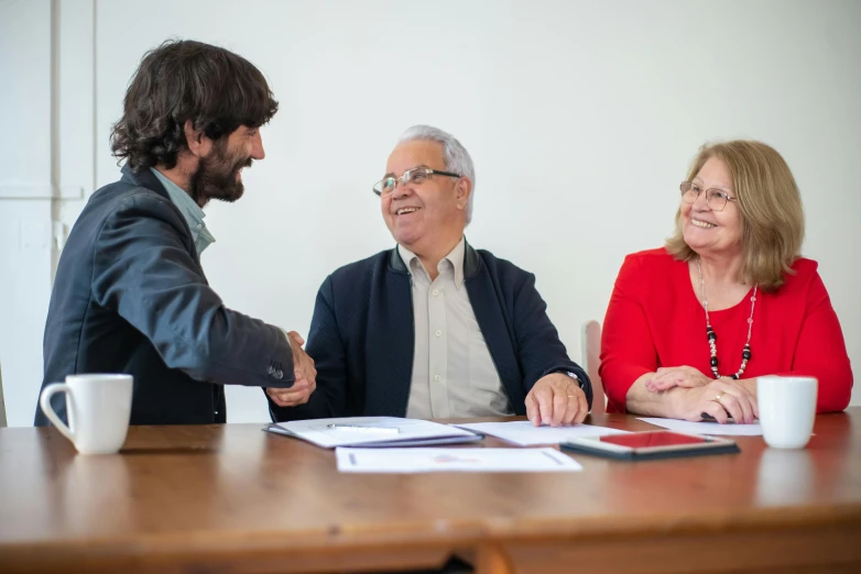 the two people are meeting with one another at the table