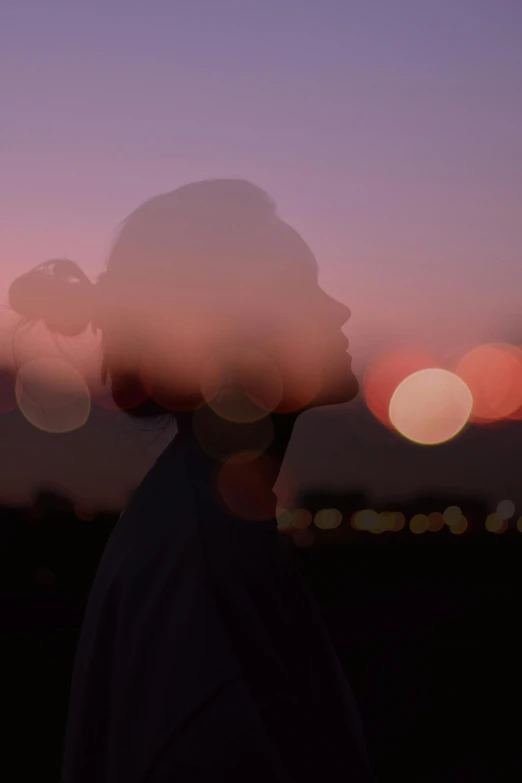 the back view of a person's head and head against a blurry background