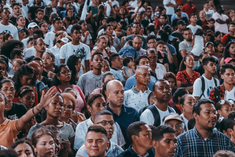 large group of people are seen from the shoulders up