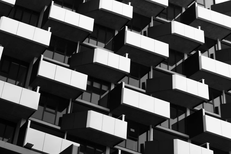 the black and white building has balconies on the roof