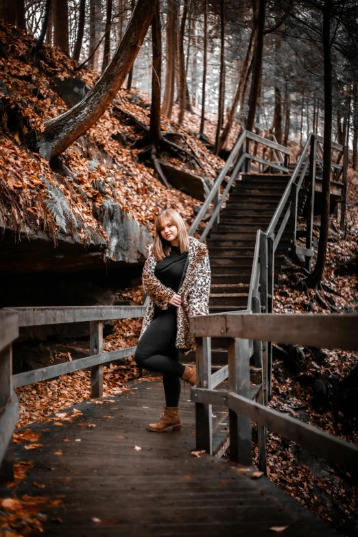 a woman in a leopard print jacket stands on the steps