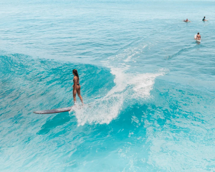 people on the water and riding waves in the ocean