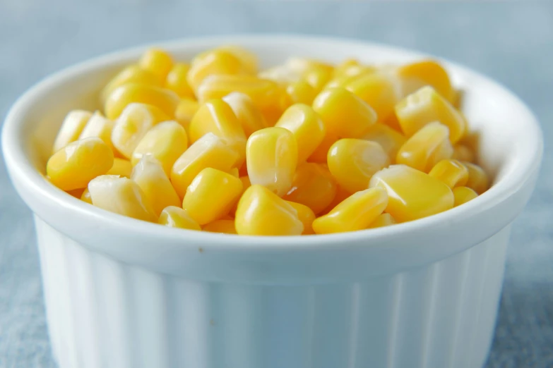 a small white bowl containing a yellow corn