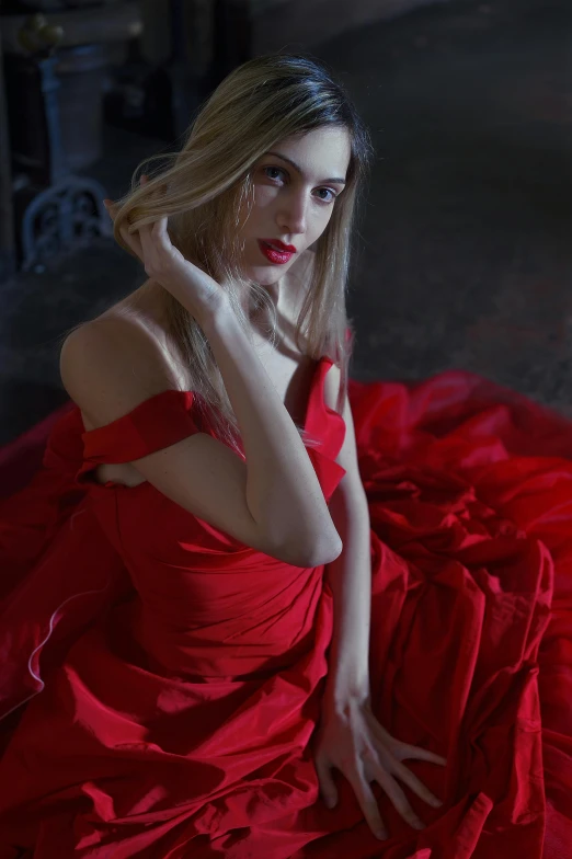 a woman with a red dress is posing