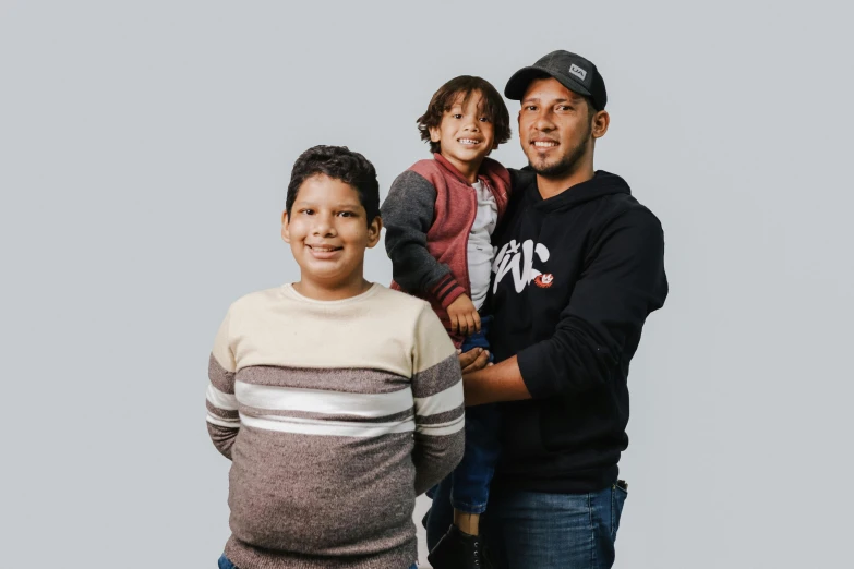 a couple of men standing next to each other with a boy on his back