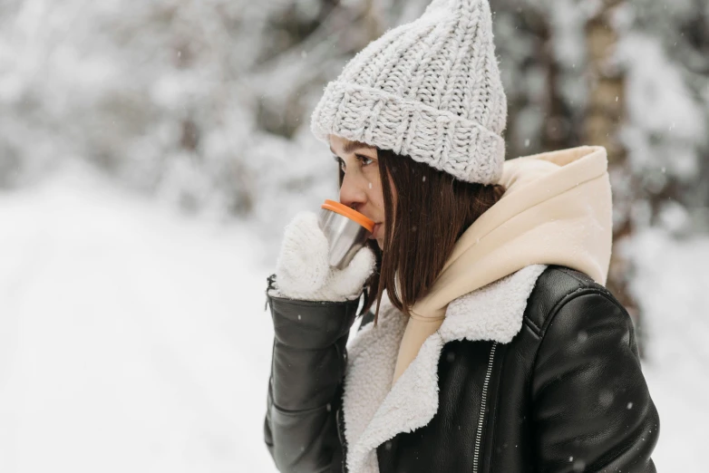 a person in winter gear talking on a cell phone