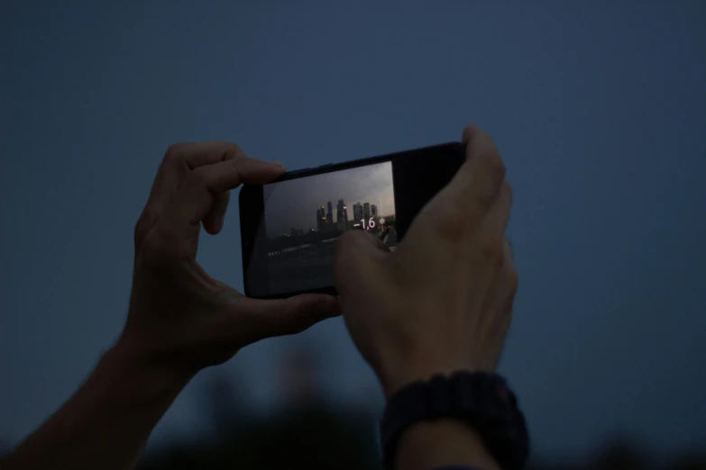 someone taking a po with their cell phone in the dark