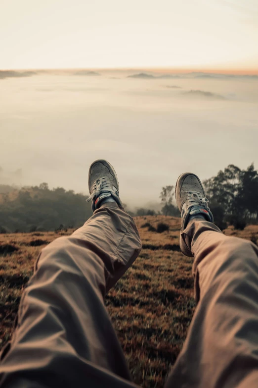 person wearing sneakers looking out at the view