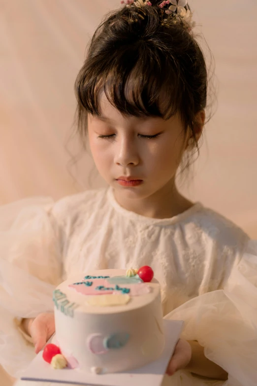 a little girl with a fancy cake on her lap