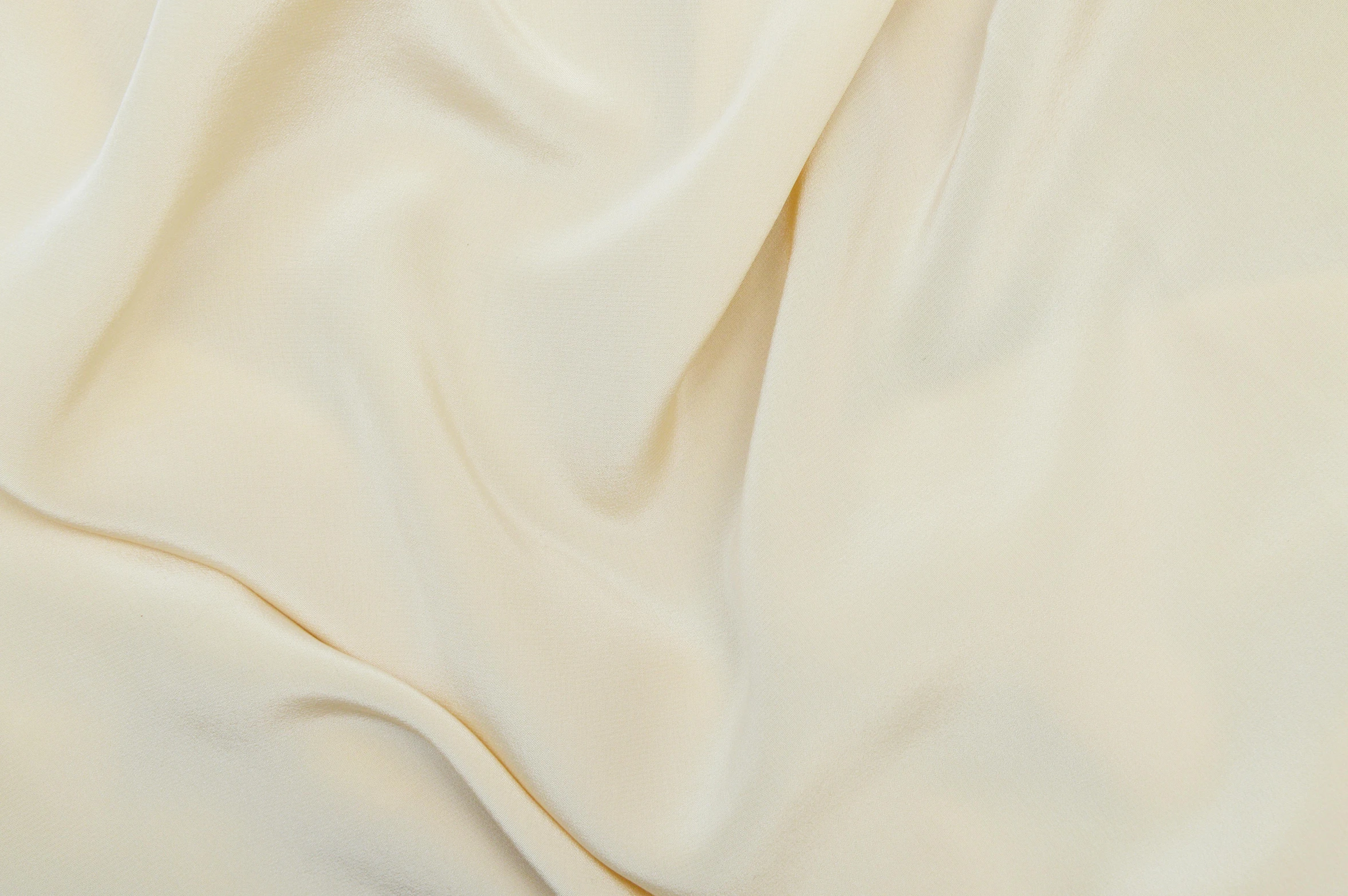 the background of an ivory fabric, which is very soft and slightly wrinkled