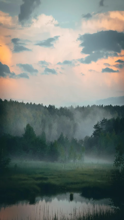 a hazy sky hangs over the valley as the sun rises