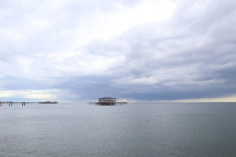 a large body of water with a pier and pier in the distance