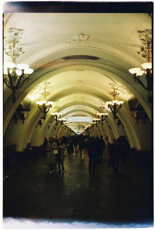 many people are walking around an underground tunnel