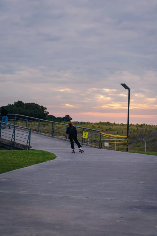 a boy is riding his skateboard down the street