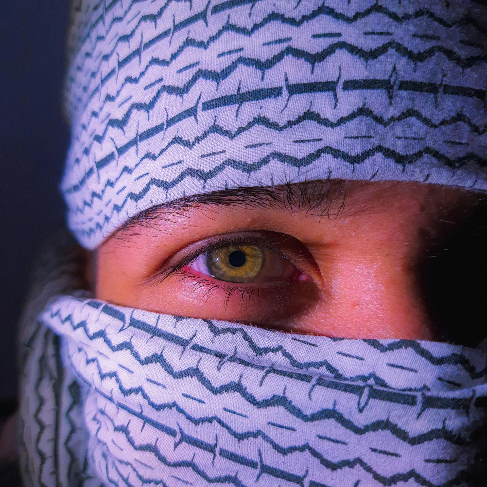 a person wearing a knitted hat with a black and white pattern on it