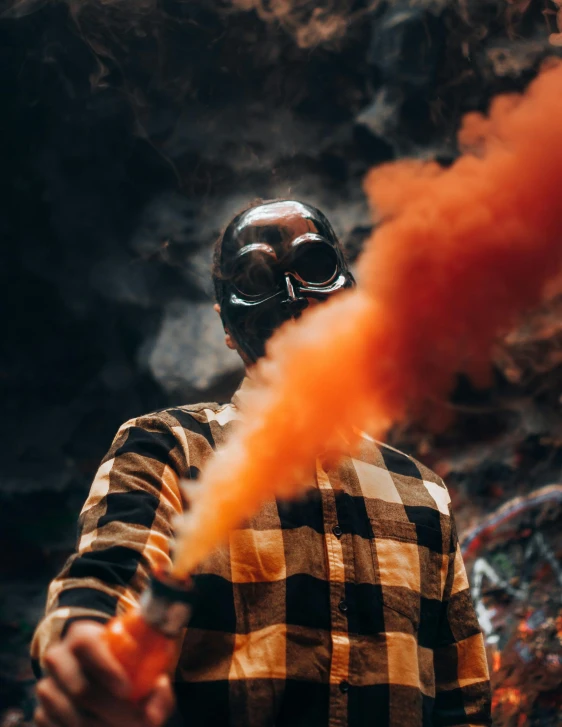 a man standing with some smoke in his mouth