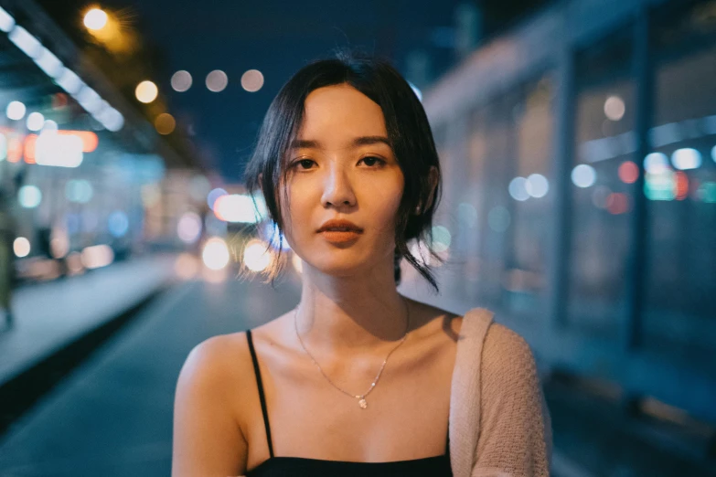 a woman looking at the camera on a street