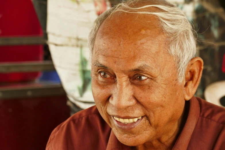 a close up of a person with an odd smile on his face