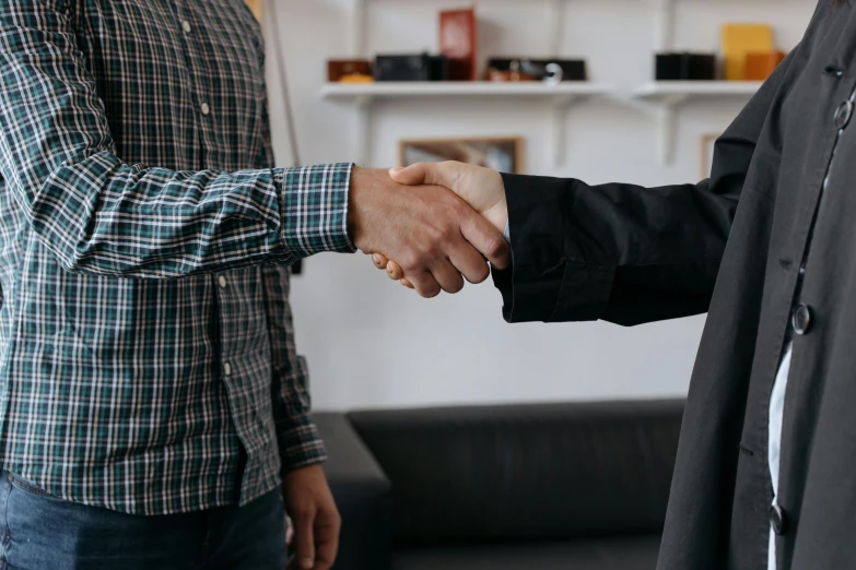 two men are holding hands with each other