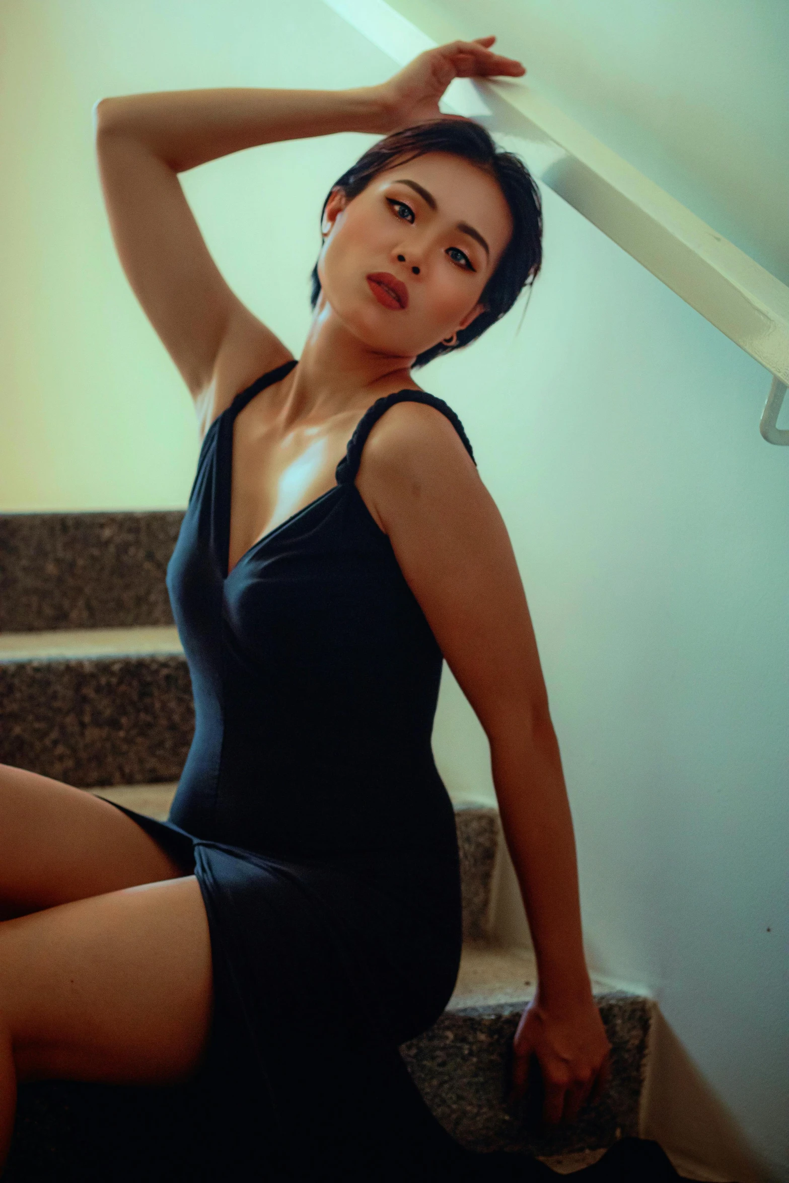 a woman posing on the step of stairs