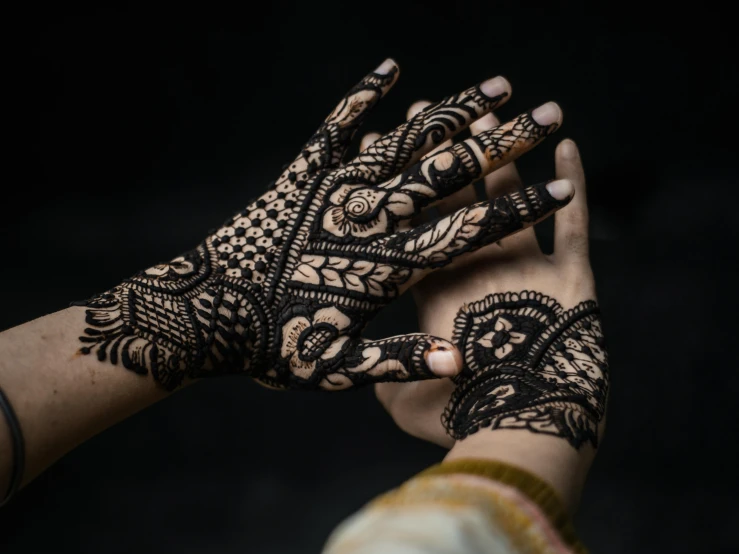 the henna is intricate and elegant on the hands