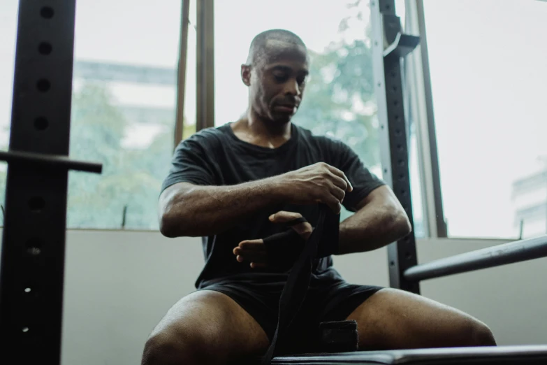 a man who is kneeling down in a gym