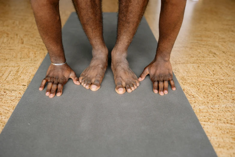 a man is on the floor doing soing with his hands