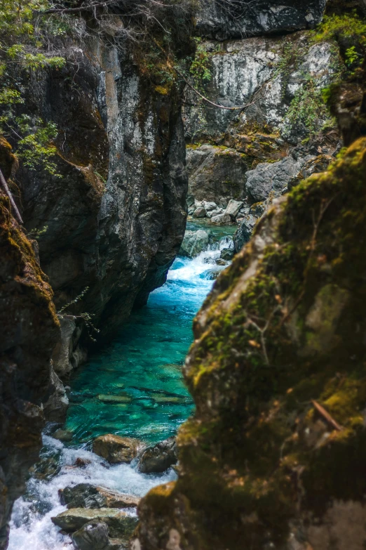 the water is running through the large hole near the rocks