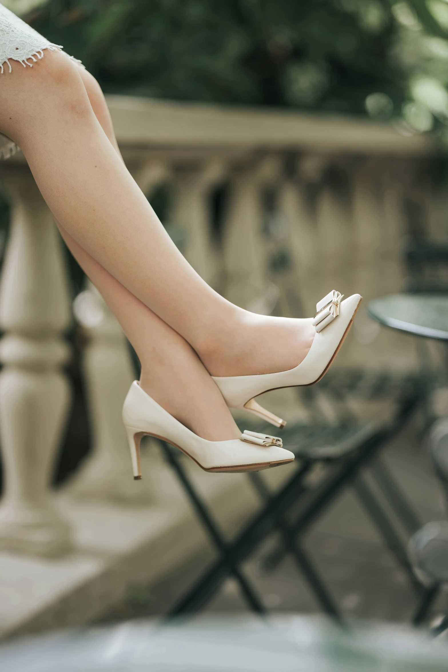 a woman's legs in heels on top of the table