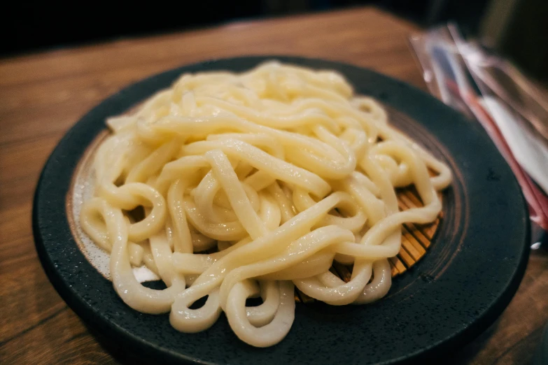 noodles in a bowl on a plate on a table