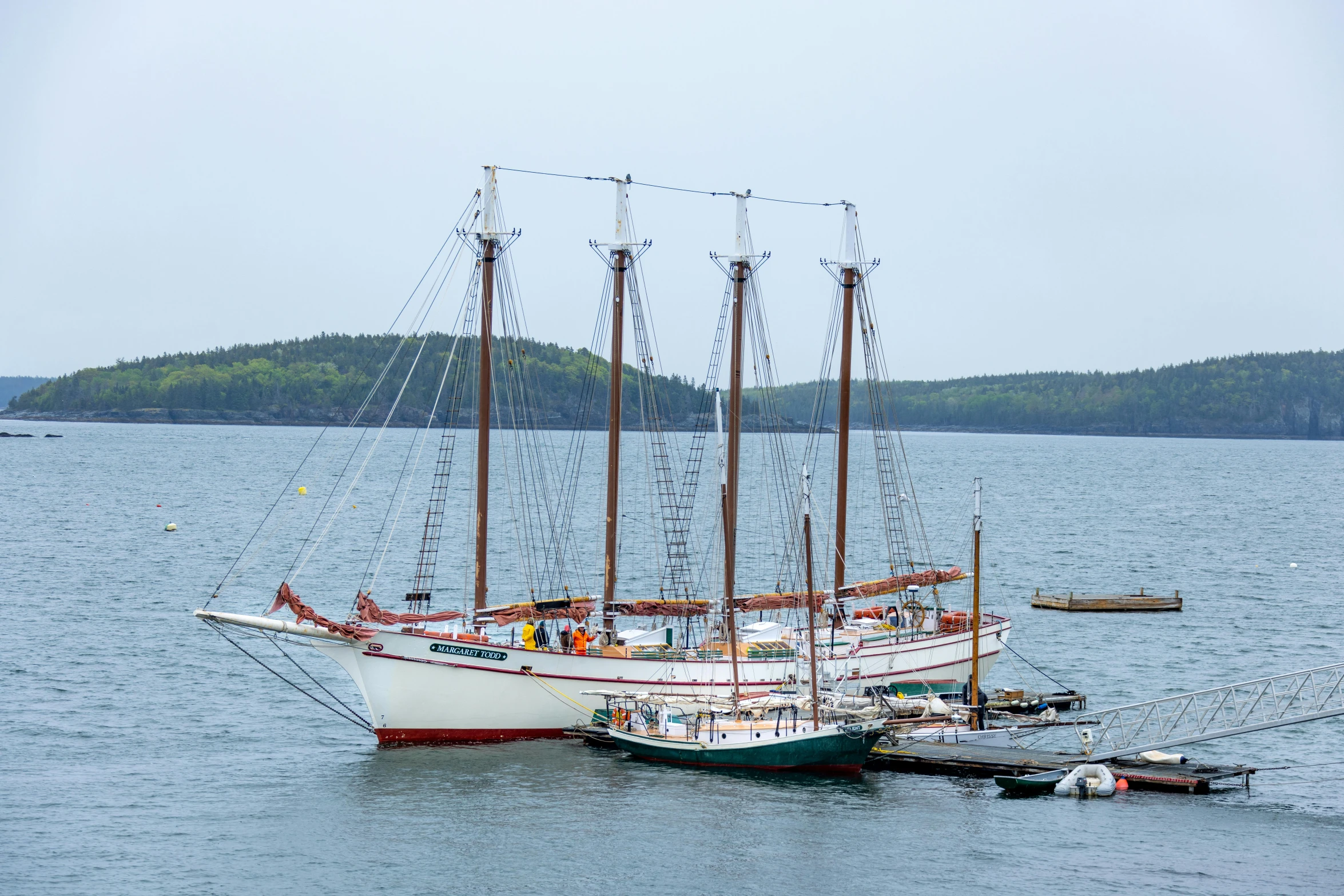 a ship on the water with other boats near it