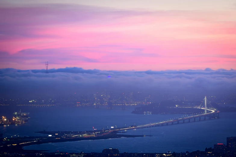 fog is covering the city and bridge from behind