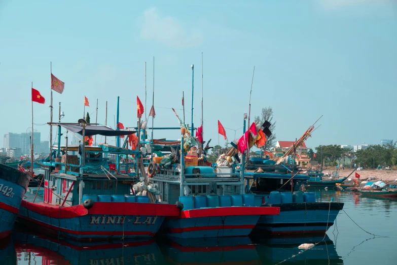 several boats sitting on the water in front of a harbor