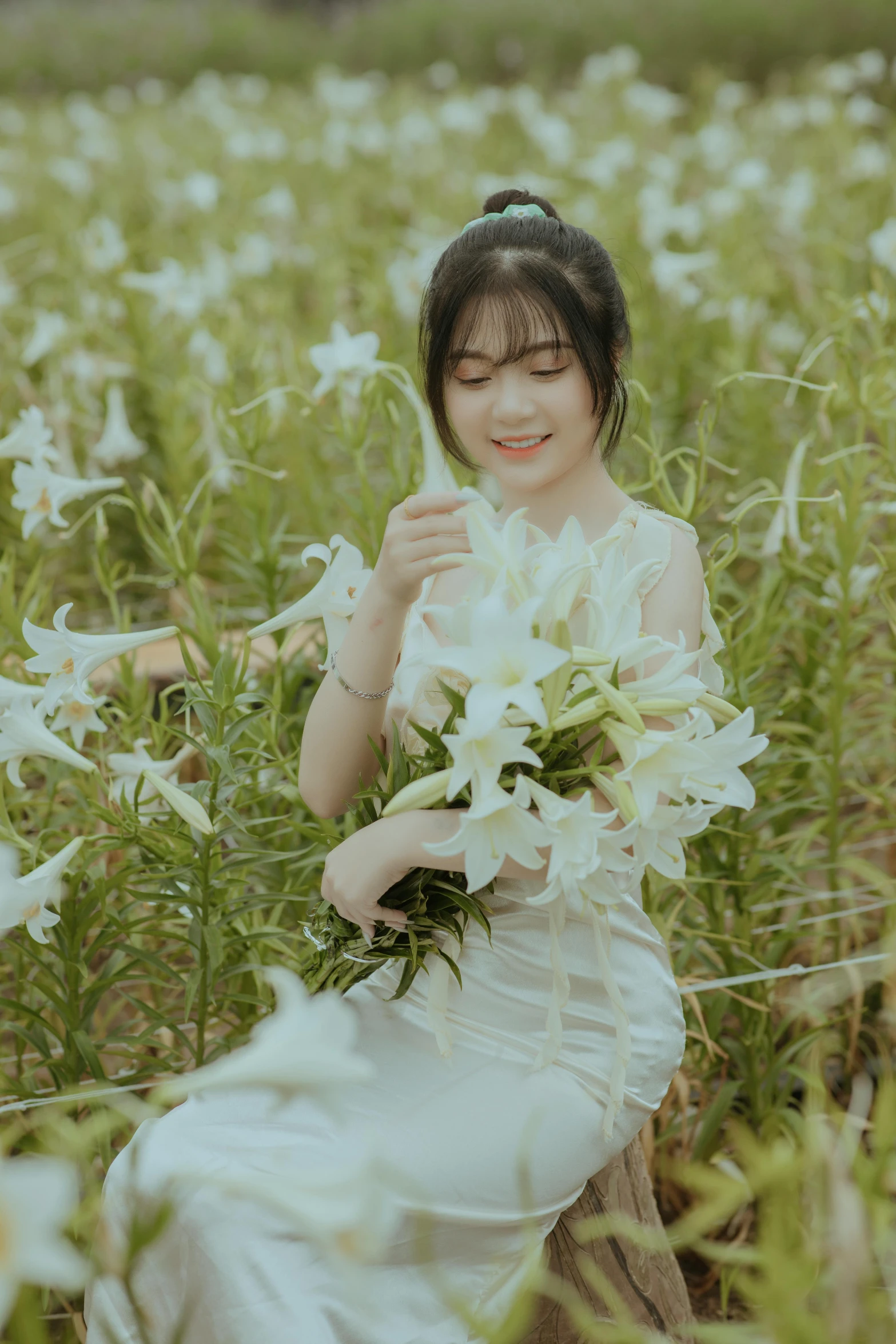 the woman is in a field with white flowers