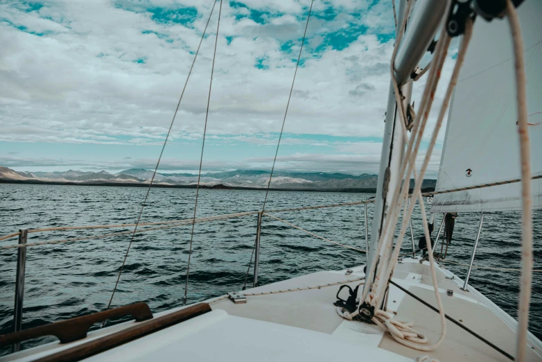 view of the ocean and a ship from the deck of a sail boat