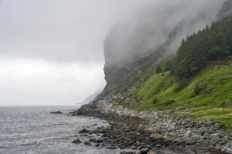 an umbrella and rock pathway along side a cliff