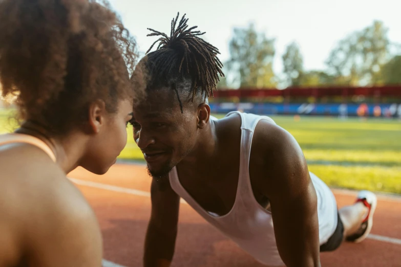 two athletes standing on one side with their backs to one another